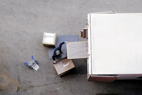 Packed boxes and furniture being loaded into a removal truck