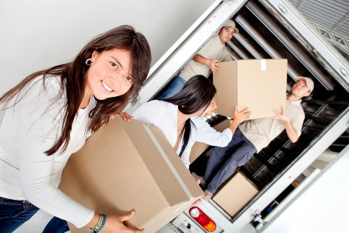 Professional movers handling furniture in a central London property