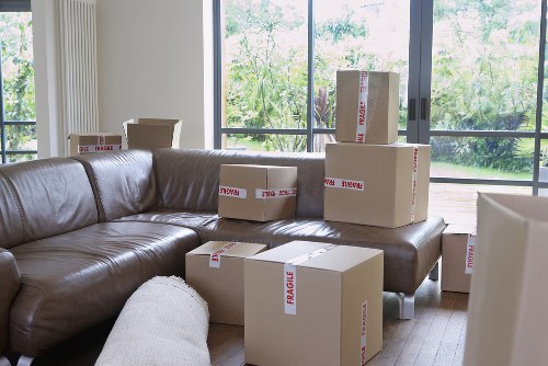 Removal staff transporting business equipment through a South Kensington property