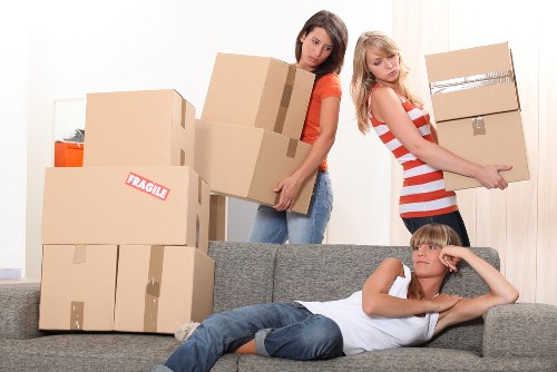 Helper carrying household items for a flat move in South Kensington